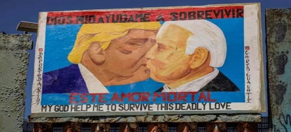 Activistas pintan mural de Trump y Joe Biden en el muro fronterizo